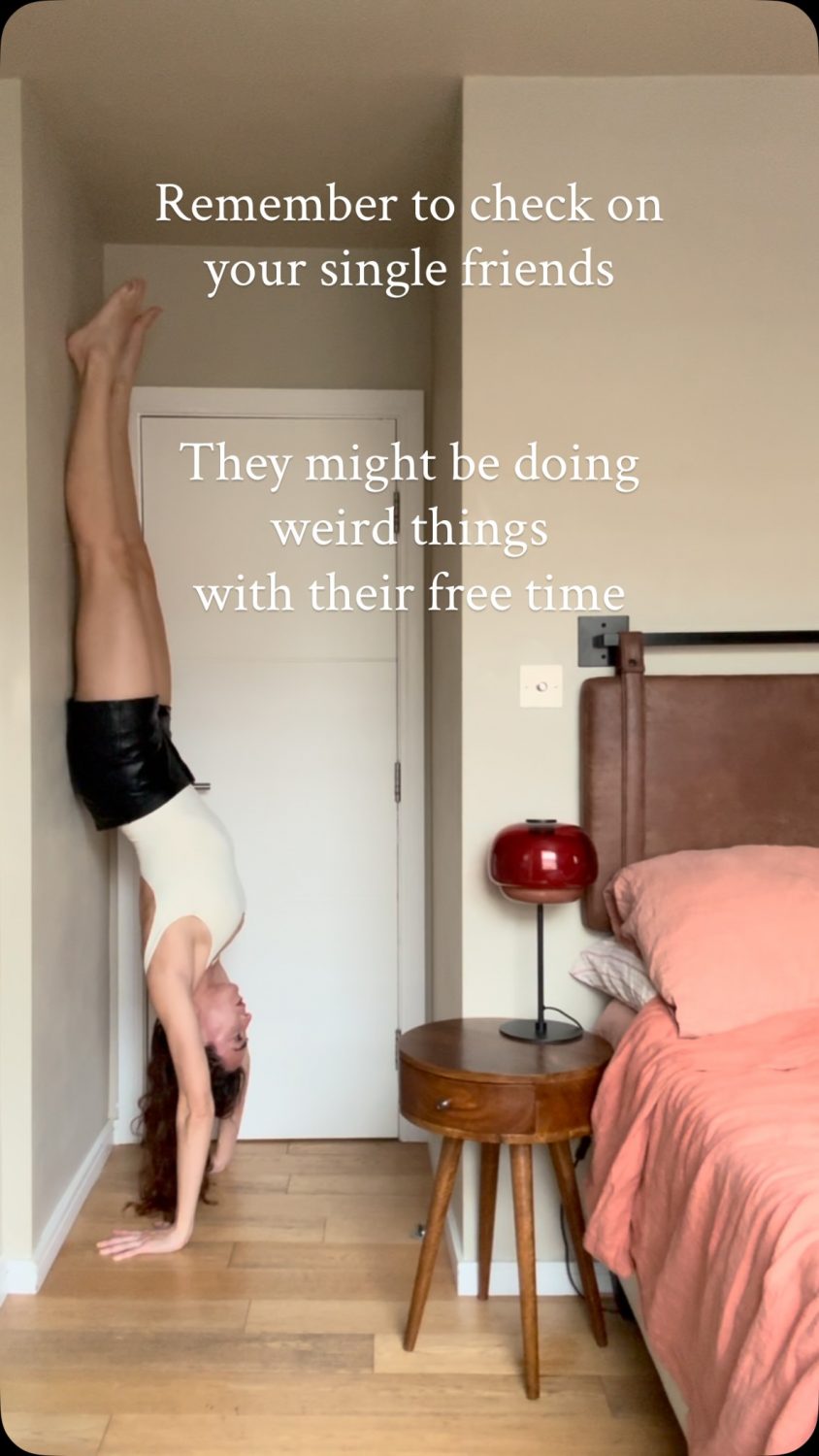 Person doing a handstand against the wall in a bedroom, with humorous text about checking on single friends.
