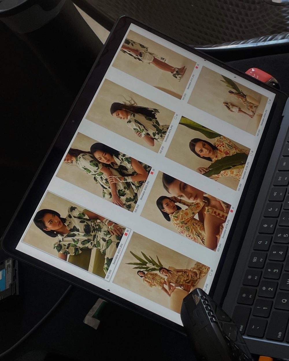 Tablet showing a grid of fashion photos featuring models in floral prints and neutral tones (lookbook styles).