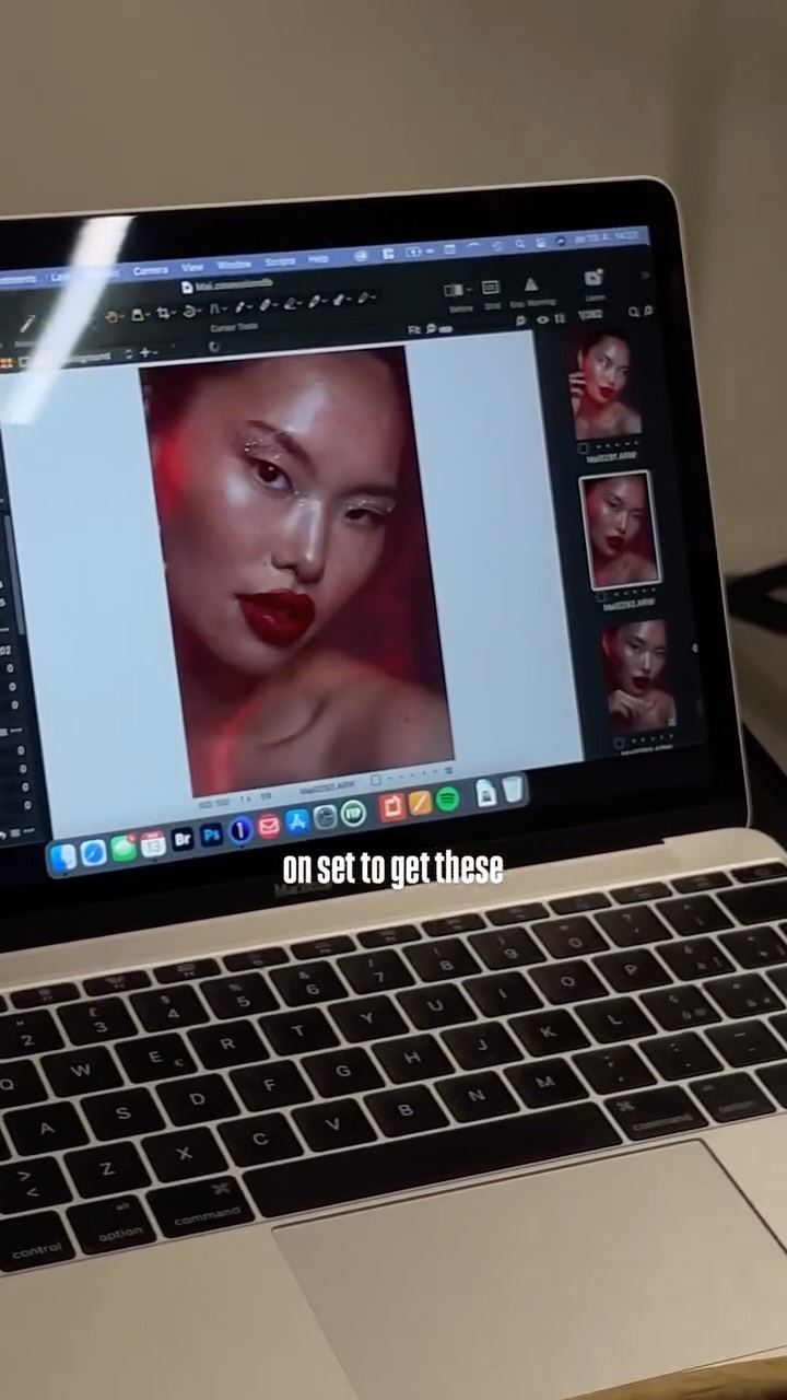 Close-up portrait of a woman with bold red lipstick being edited in photo software on a laptop screen.