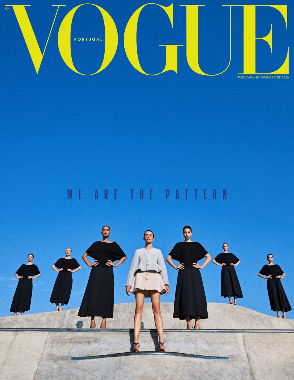 Vogue Portugal cover: models in black dresses with a central figure in beige, posed on steps against a bright blue sky; the headline 'WE ARE THE PATTERN'.